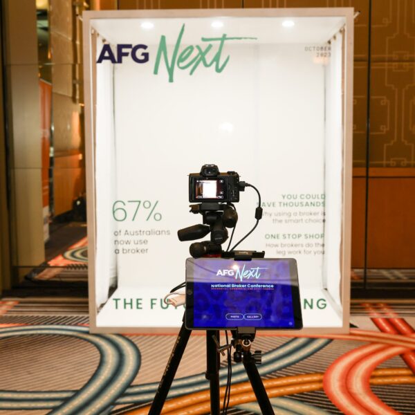 Camera tripod set up in front of photo booth