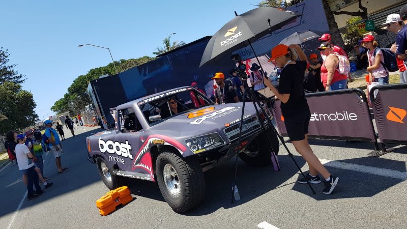 people enjoying getting into a boost super truck for a photo